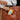Person holding a brown leather bag with a packet of Peanut Envy Sattva Vida Energy Bites.